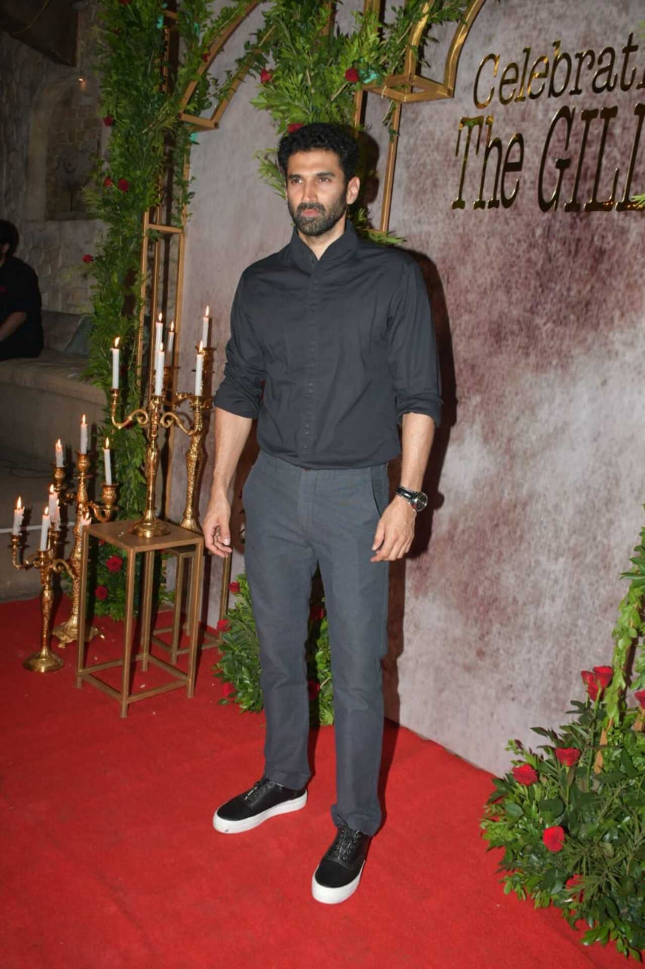 The actor wore a black shirt and trousers for the celebration